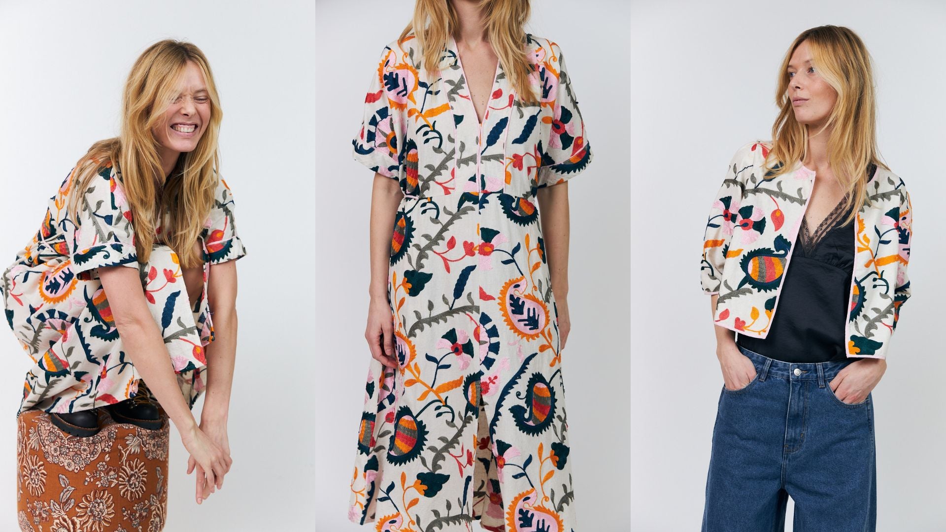 Woman wearing a colorful floral dress and jacket on a white background