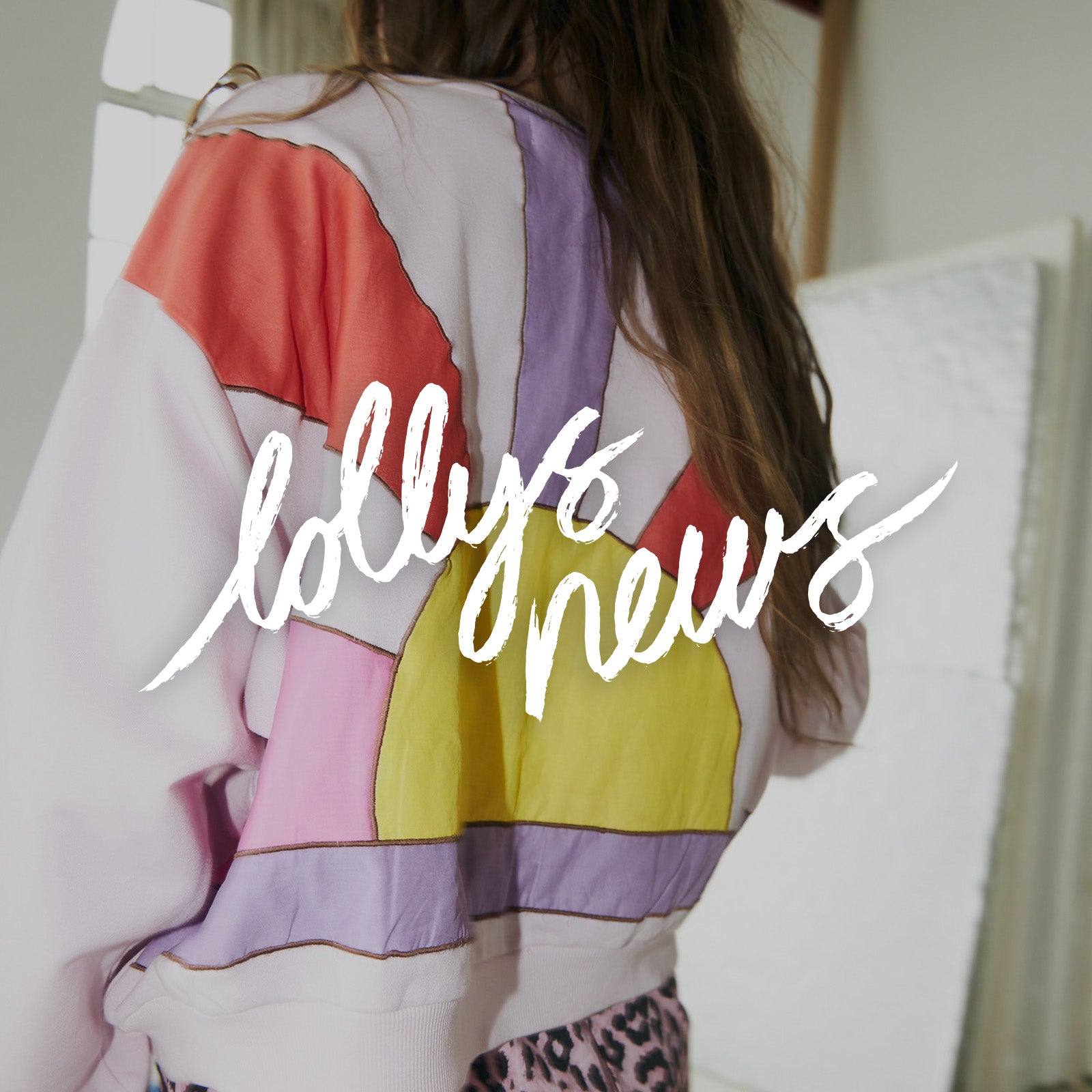 Model wearing a colorful sweatshirt with soft pastel tones from Lollys Laundry new arrivals
